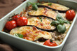 Delicious eggplant lasagna in baking dish on table, closeup