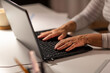 © Syda Productions - technology and people concept - close up of senior woman hands typing on laptop at home