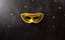 Happy Purim Carnival Decoration Concept Made From Golden Mask And Sparkle Star On Dark Background. (Happy Purim In Hebrew, Jewish Holiday Celebrate)