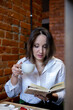 © Дарья Колпакова - Young woman drinks coffee from a cup. Business lunch break.