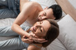 © LIGHTFIELD STUDIOS - overhead view of sexy woman smiling with closed eyes near blurred shirtless boyfriend.