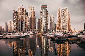 Wall Mural - DUBAI, UAE - FEBRUARY 2018: View of modern skyscrapers shining in sunrise lights  in Dubai Marina in Dubai, UAE.