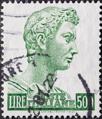 Wall Mural - Italy - circa 1957: a postage stamp from Italy showing the Head of the statue of St. George,  green