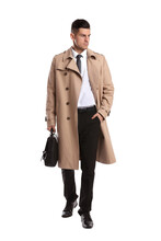 Businessman in trench coat with stylish leather briefcase on white background