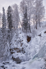 Fototapete - Photo of frozen river Pescherka near waterfall in winter. Siberia, Russia