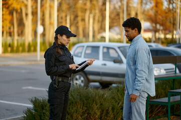 Female cop checking male passerby ID document