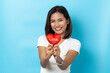 © suriya - Love and valentines day, asian girl holding red heart shape isolated on blue background