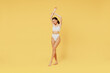 © ViDi Studio - Full body young sexy brunette woman 20s wear white underwear with perfect fit figure raise up hands close eyes isolated on plain yellow color background studio portrait. People female beauty concept