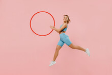 Full Body Young Strong Sporty Athletic Fitness Trainer Instructor Woman Wear Blue Tracksuit Spend Time In Home Gym Hold Hula Hoop Isolated On Pastel Plain Light Pink Background. Workout Sport Concept.