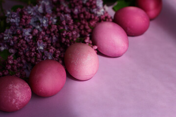  Close-up of beautiful lilac Easter eggs with blooming lilac branches. Easter decor. Selective focus.