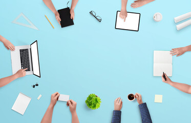 Business people working and communicating at the office desk. Top view, flat lay composition with copy space in the middle