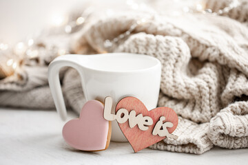 Wall Mural - Composition for Valentine's Day with a cup and a heart-shaped gingerbread.