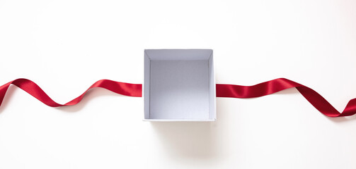 Wall Mural - valentine day gift, open white box and red satin ribbon isolated on white, empty space.