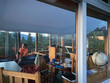 © Cavan Images - Female watching sunset from inside a fire lookout in the Cascades