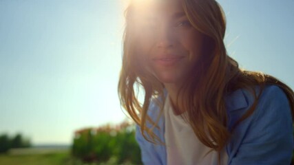 Wall Mural - Portrait of happy woman smiling in summer floral background in soft sunset light