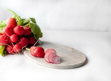 Group Of Fresh Red Radish Chopped On Wooden Board Isolated On White Background
