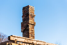 Remains Of An Old Brick Chimney On A Sunny Day