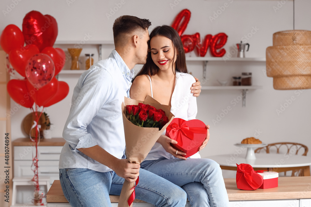 Young man greeting his girlfriend for Valentine's Day at home