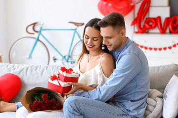 Beautiful young couple celebrating Valentine's Day at home