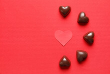 Tasty Heart-shaped Candies On Red Background