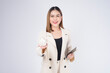 © tonefotografia - Young beautiful woman in suit holding small model house over white background studio