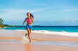 © Maridav - Running athlete woman exercising on beach run jogging living healthy active lifestyle. Fit and active Asian girl training