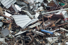 Pile Of Scrap Rusty Metal Waste On Recycling Yard. Disposal And Secondary Metal Recycling.