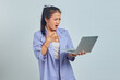 © Bangun Stock Photo - Portrait of surprised young Asian woman receiving project emailed on laptop isolated on white background