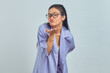 © Bangun Stock Photo - Portrait of charming young Asian woman hold hand palms send air kiss to boyfriend over white background