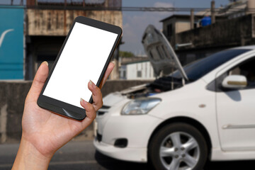 Wall Mural - Close up hand of woman using smartphone and blur of her broken car parking on the road.