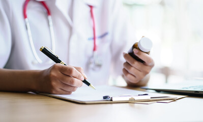 Female doctor checking drug information on drug registration paper.