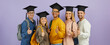 © Studio Romantic - Education and success: Happy confident multiracial male and female university students, classmates and best friends in graduate hats give thumbs up standing together on purple color studio background