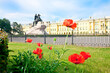 The monument to Peter the Great on the background of red flowers in St. Petersburg, Russia