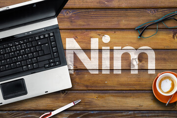 nim programming language. word nim on wooden desk and laptop