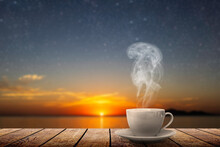 Hot Coffee On The Table Against The Background Of The Sea Dawn