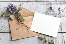 Wedding Invitation Or Greeting Card Mockup With Lavender And Eucalyptus Flowers On Wooden Background