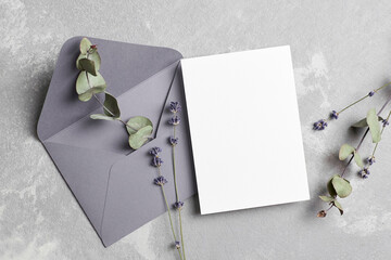 Wall Mural - Greeting or wedding invitation card mockup with envelope, dry lavender and eucalyptus twigs