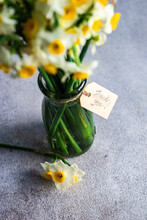 Overhead View Of A Bunch Of Narcissus Flowers In A Vase With A Thank You Tag