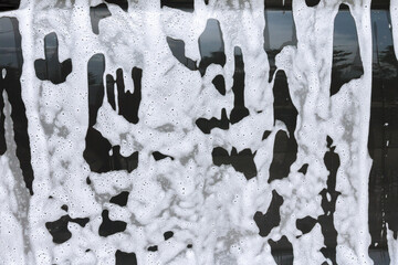 Canvas Print - Cleaning dirt from the machine on a self-service car wash.