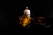 Holocaust Memory Day. Arbed Wire And Burning Candle On Black Background