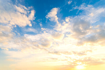 Wall Mural - Sky blue and orange light of the sun through the clouds in the sky