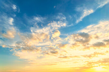 Wall Mural - Sky blue and orange light of the sun through the clouds in the sky