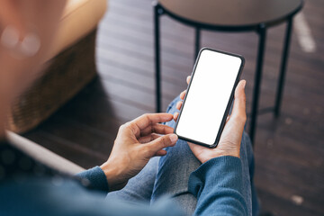 cell phone blank white screen mockup.hand holding texting using mobile on desk at office.background 