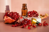 Fototapeta Tulipany - Composition with natural cosmetic oil and pomegranate on light background