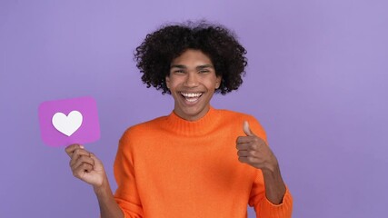 Canvas Print - Millennial guy hold heart follower fist up isolated vivid color background 