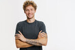 © Drobot Dean - Young blonde man with curly hair smiling and looking at camera