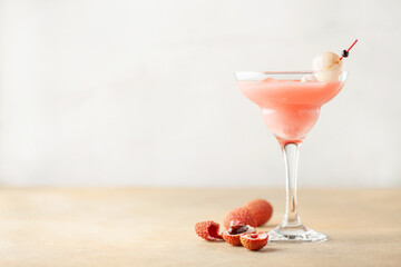 Wall Mural - Delicious lychee cocktail in Margarita glass and fresh fruits on  table.