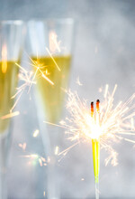 Sparklers In Front Of Two Glasses Of Champagne