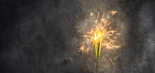 Close-up Of Sparklers Against A Grey Background