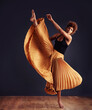 © Mapodile M./peopleimages.com - Dedication to expression. Female contemporary dancer in a dramatic pose against dark background.